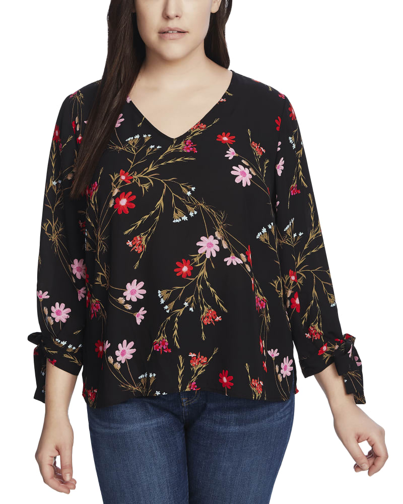 Front of a model wearing a size 1X Sophie Tie-Sleeve Blouse in RICH BLACK by CeCe. | dia_product_style_image_id:264016